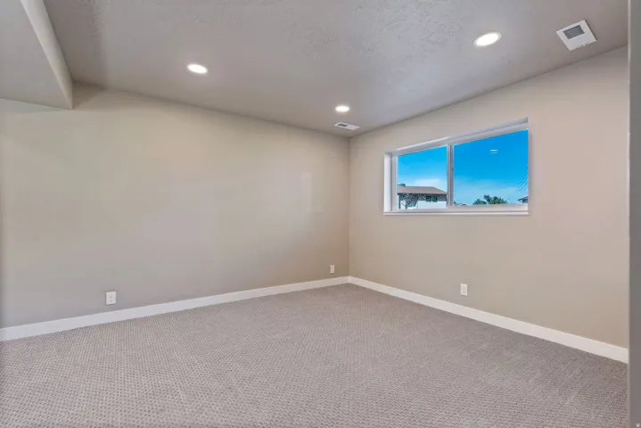 Recessed ceiling lighting, carpeted flooring, and a double-pane window