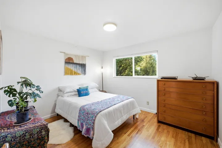 Hardwood flooring, light wall color, recessed lighting, and a double window
