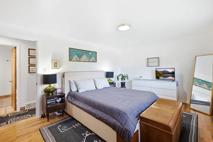 Hardwood flooring, recessed lighting, and a neutral color palette