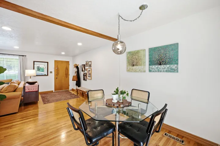 Hardwood flooring throughout, recessed lighting, and a wood-finish ceiling beam