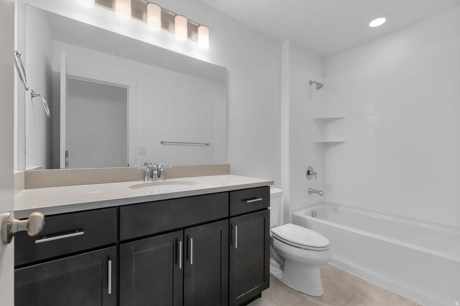 Dark wood-finish vanity with an integrated sink, light-toned countertop, and chrome fixtures
