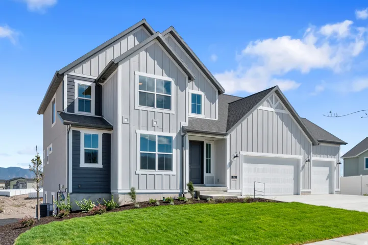 Contemporary exterior with board and batten siding, multiple gables, and a three-car garage