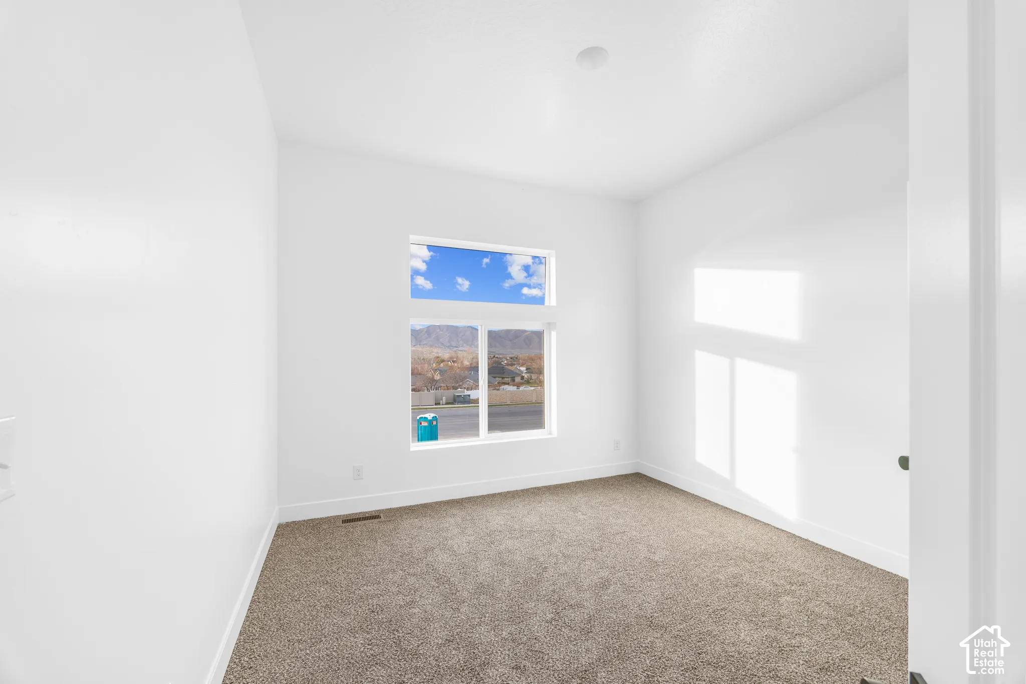Neutral wall finishes and plush carpeting