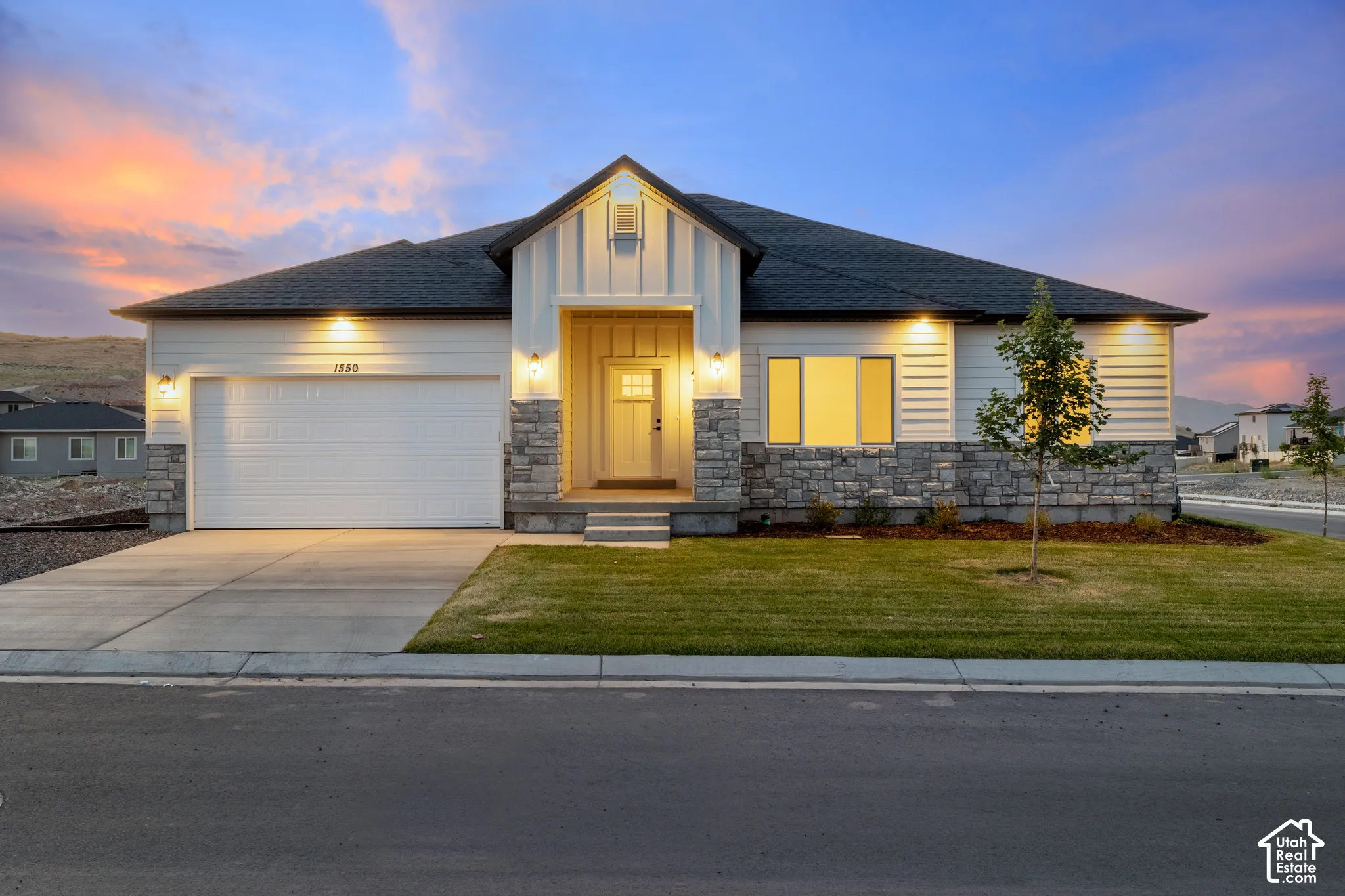 Modern exterior with white siding and stone accents