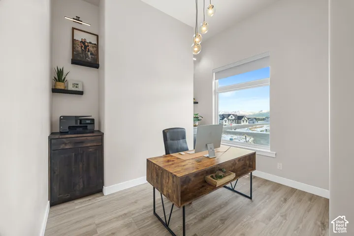 Vaulted ceiling, wood-finish flooring, built-in shelving, built-in cabinet, large window