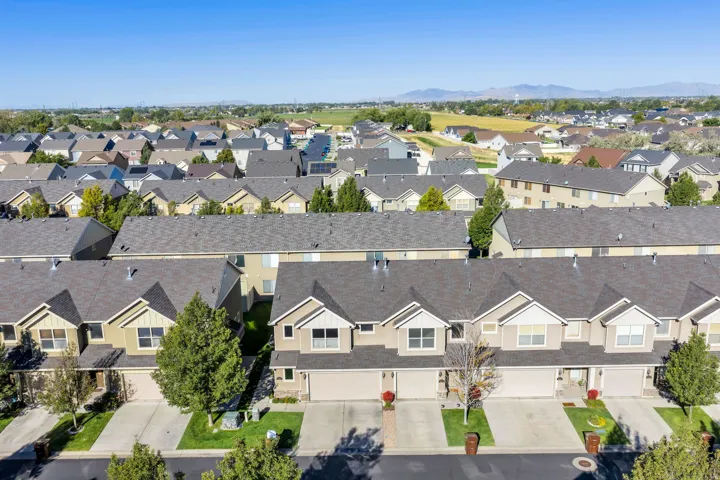 Row of residential properties with attached garages and driveways