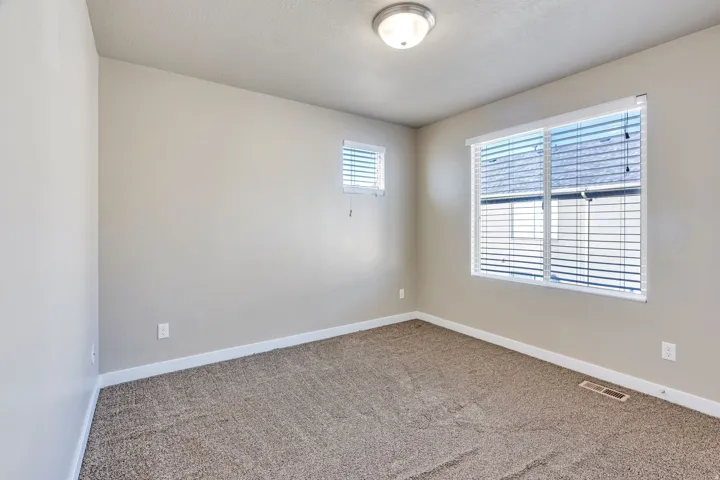 Neutral toned walls with textured carpet flooring