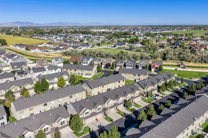 Residential development featuring multiple housing styles, paved roadways, and mature landscaping