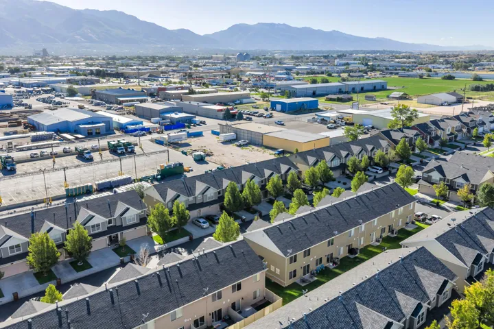Townhome development featuring multiple units with dark shingle roofs and light-colored siding