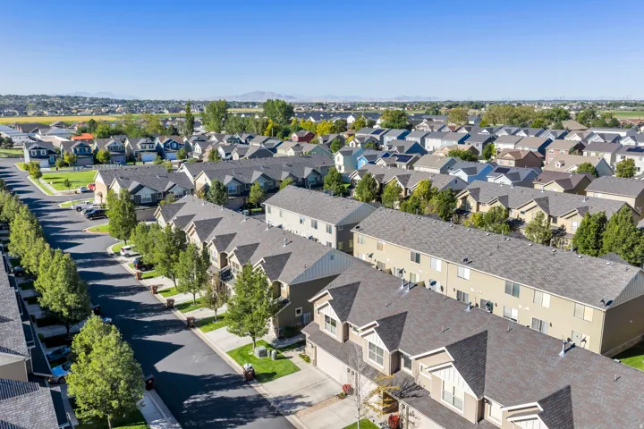 Expansive neighborhood with rows of residential properties, featuring mature street trees and well-maintained paved streets