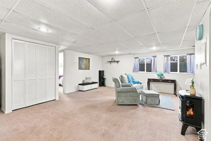 Expansive carpeted area with recessed lighting, white walls, and multiple windows