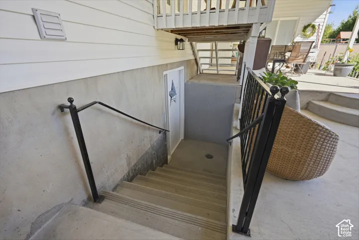 Concrete staircase with black metal railings