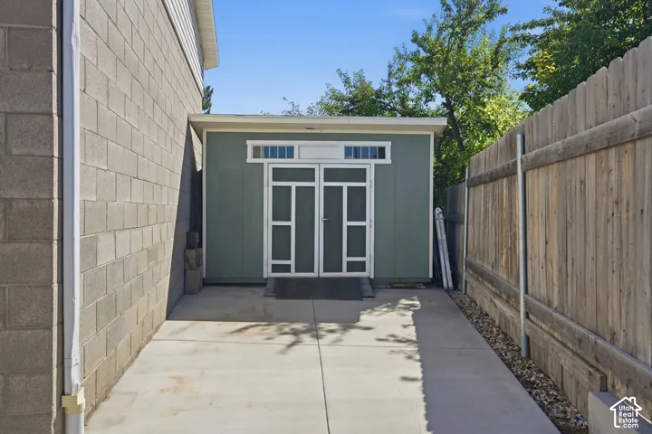 Detached shed featuring transom windows and double entry doors
