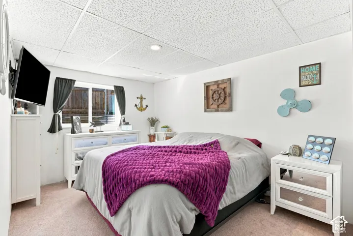 Recessed lighting, wall-mounted television, and a window with dark curtains