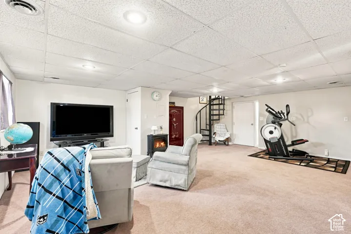 Recessed lighting, spiral staircase, and carpeted flooring