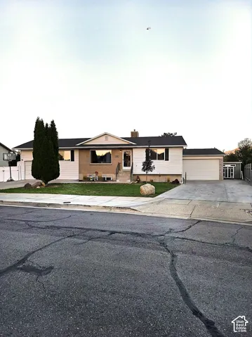 Single-story residence featuring a two-car garage, an additional single-car garage, and a concrete driveway