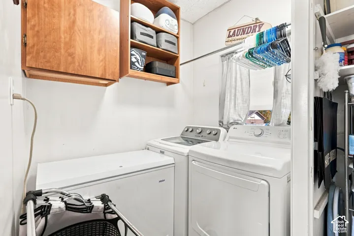 White washer and dryer with a chest freezer