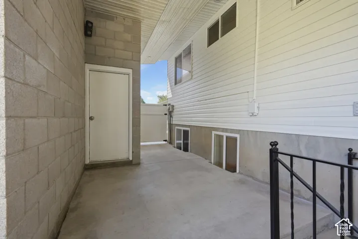 Concrete block wall leading to a solid exterior door