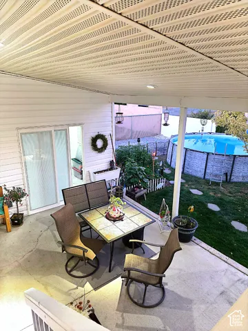 Covered patio with concrete surface and exterior lighting