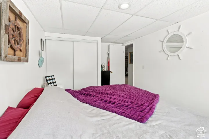 Recessed ceiling lighting, white walls, and a sliding closet door