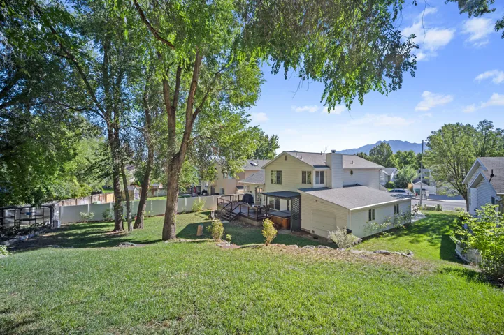 Expansive grassy yard with mature trees