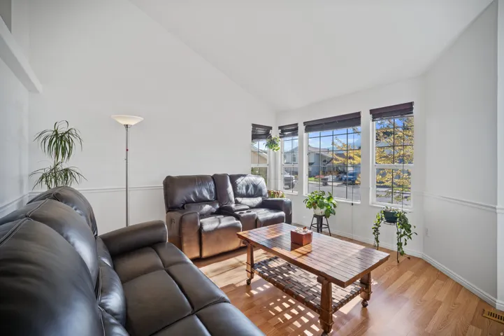 Vaulted ceilings, wood-finish flooring, and crisp white walls