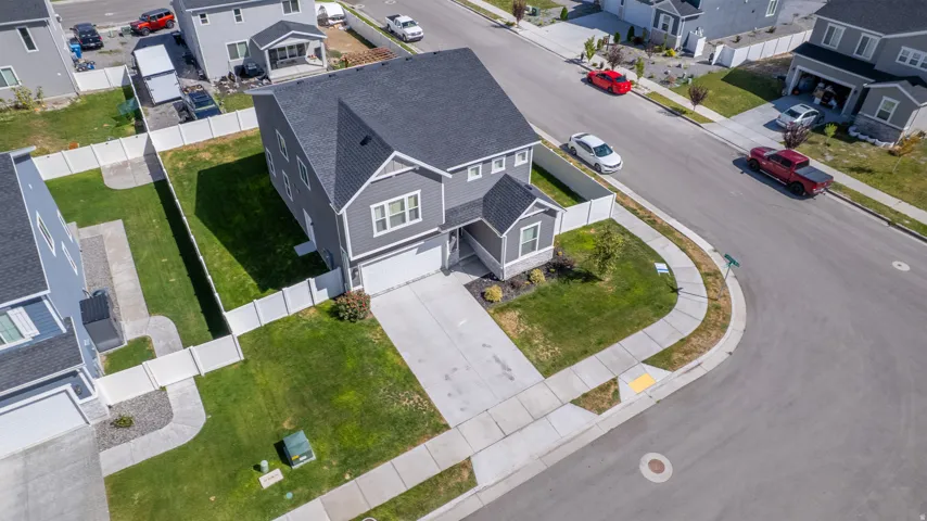 Two-story residence with a dark shingle roof, light gray siding, and an attached two-car garage