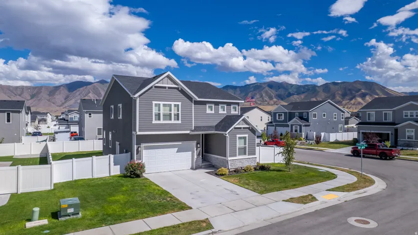 Two-story residence with gray siding and stone accents