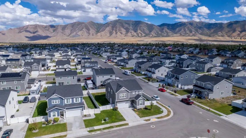 Residential community with uniform housing styles and mountain backdrop