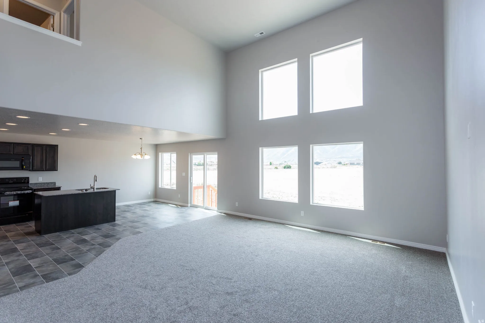 Vaulted ceilings in a spacious living area with abundant natural light from multiple windows