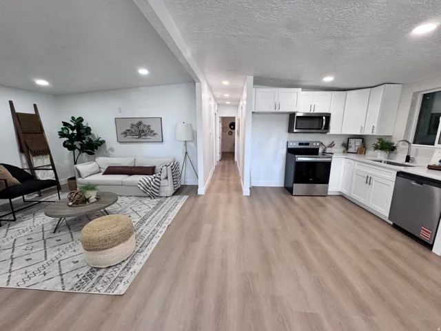 Open-concept living space with wood-finish flooring throughout