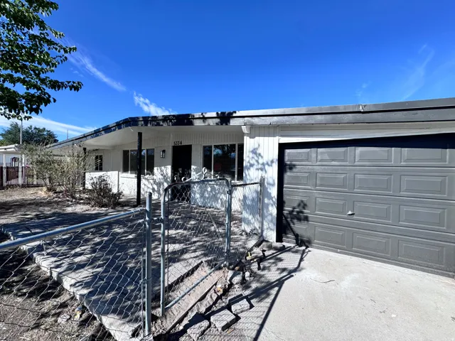 Attached single-car garage with a panel door