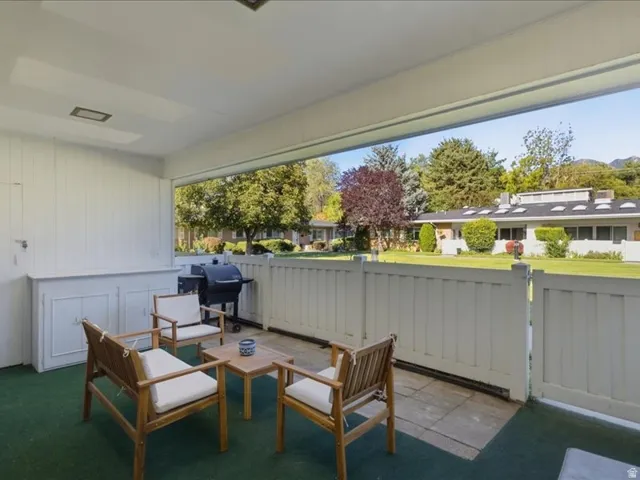 Covered patio with integrated storage cabinetry and privacy fence
