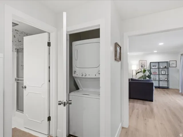 Integrated stacked washer and dryer in a dedicated utility closet