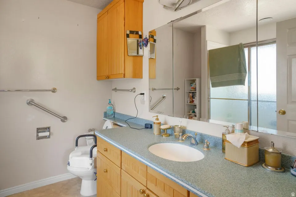 Wood-finish vanity with an integrated sink and light-colored countertop