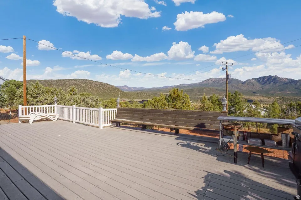 Expansive deck featuring composite decking, white perimeter railing, and a built-in wooden bench