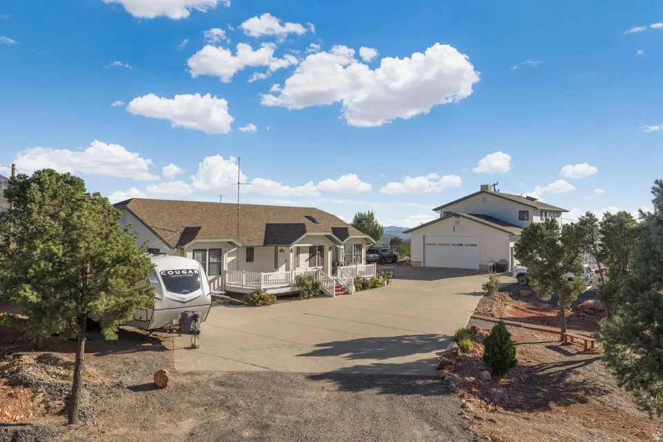 Expansive paved driveway with two distinct residential structures