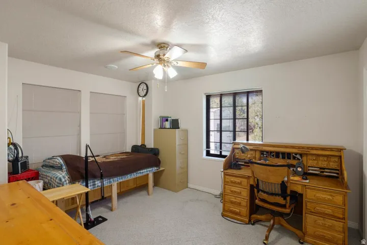 Recessed lighting, ceiling fan with integrated light, multiple windows, and light-toned carpeting
