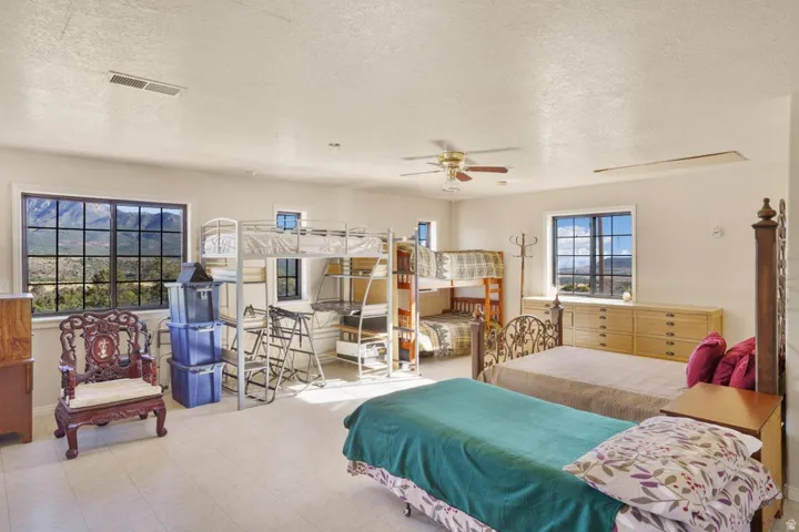 Recessed lighting, ceiling fan, multiple windows, and light-toned flooring