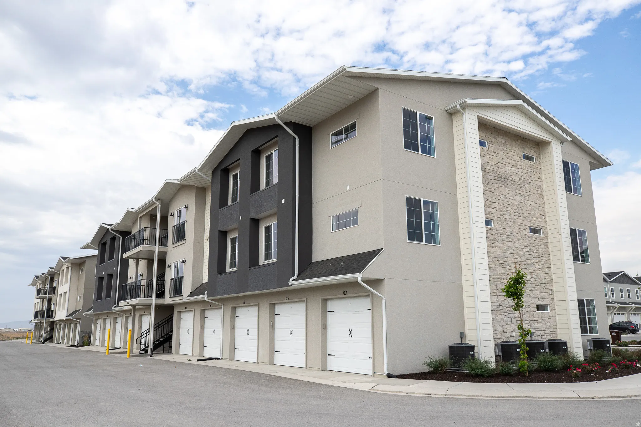 Rear view of building with garages for units.