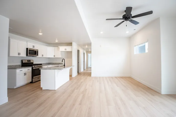 Open dining area adjacent to kitchen and family room with hallway to bedrooms.