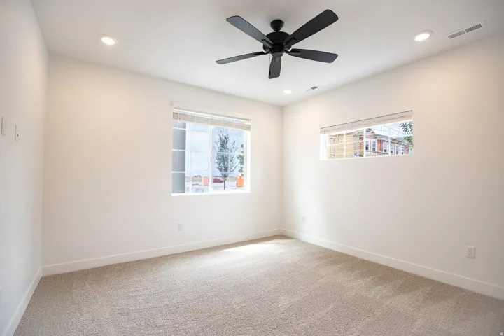 Primary bedroom with 9' ceiling and ceiling fan.