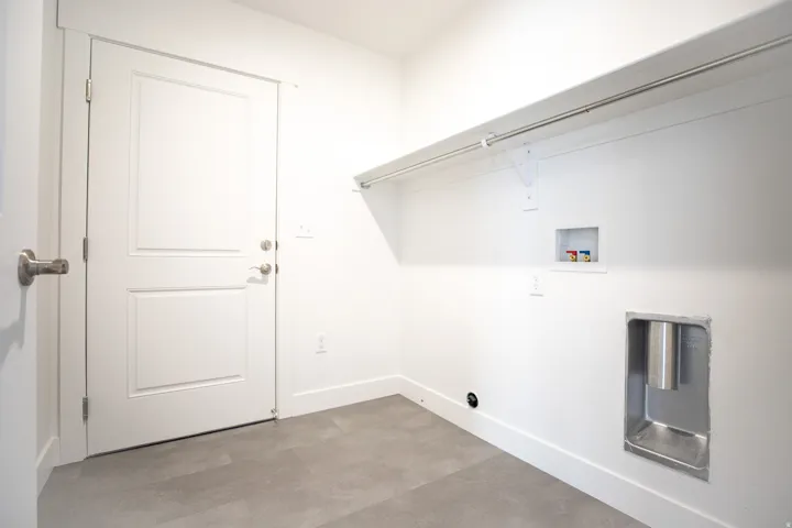Full-size, dedicated laundry room with door to garage and washer/dryer hookups.