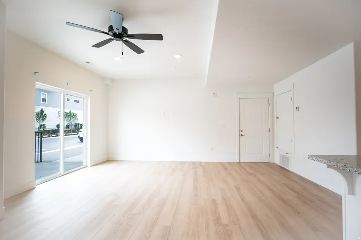 Family room with sliding glass doors to balcony area, 9' ceiling and ceiling fan.
