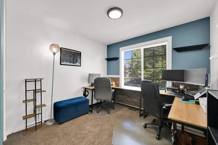 Window with blinds, recessed ceiling light, and wall-mounted shelving