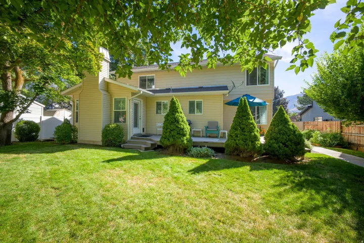 Expansive green lawn with established trees and mature landscaping
