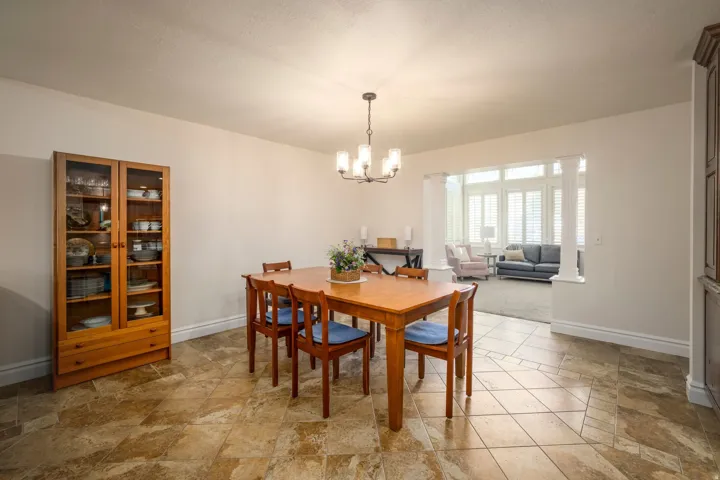 Tiled flooring in a varied pattern, with a built-in display cabinet featuring glass doors and drawer storage