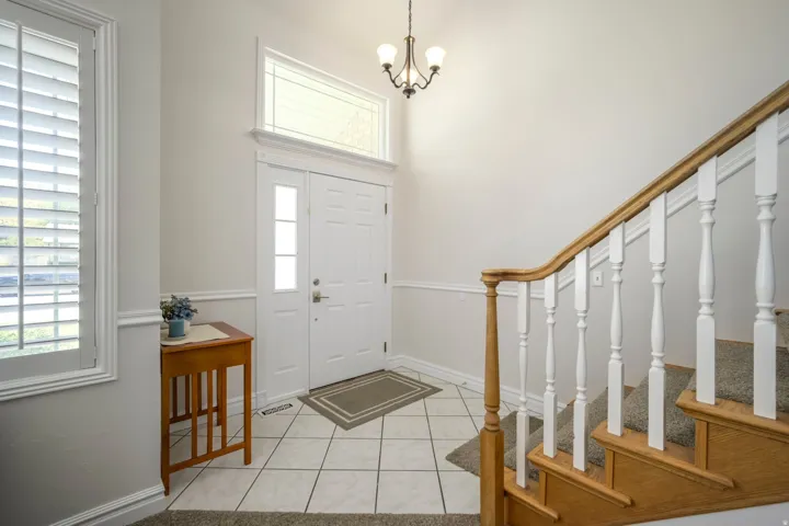 Entryway featuring a double door, transom window, and tiled flooring