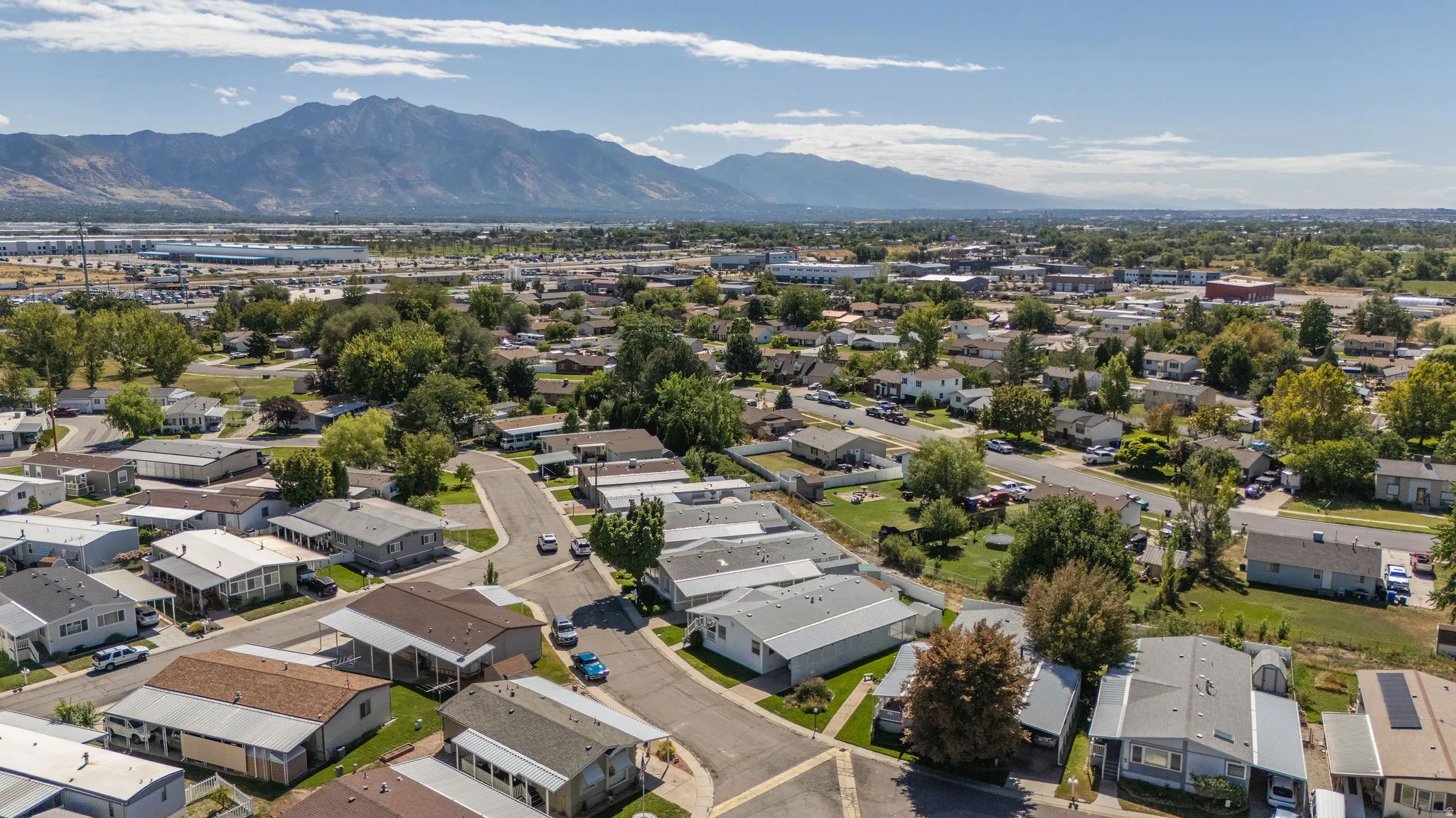 Residential community with mountainous backdrop and mature trees