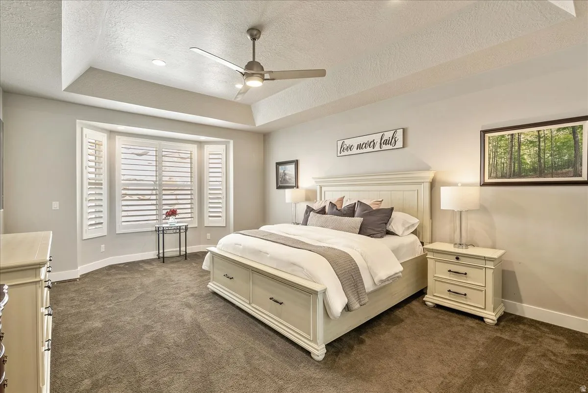 Main Floor Primary Suite-Tray ceiling with recessed lighting and ceiling fan